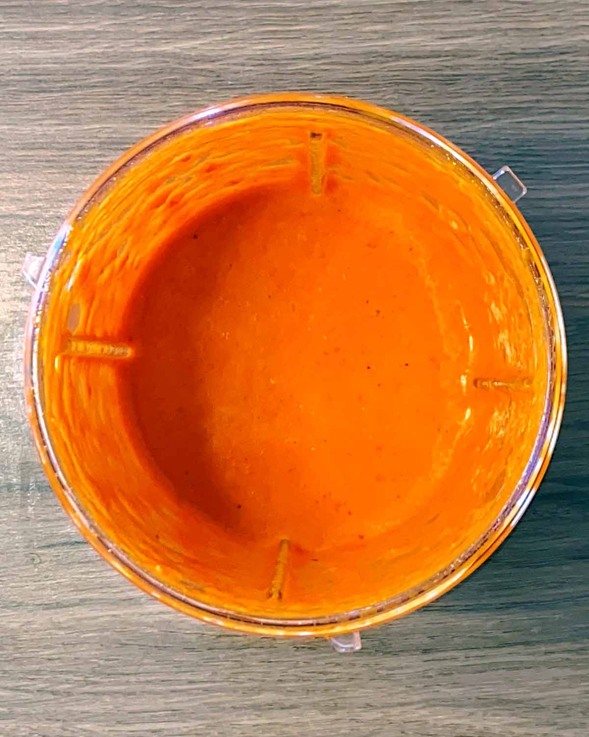 An orange sauce blended in the blender jug.