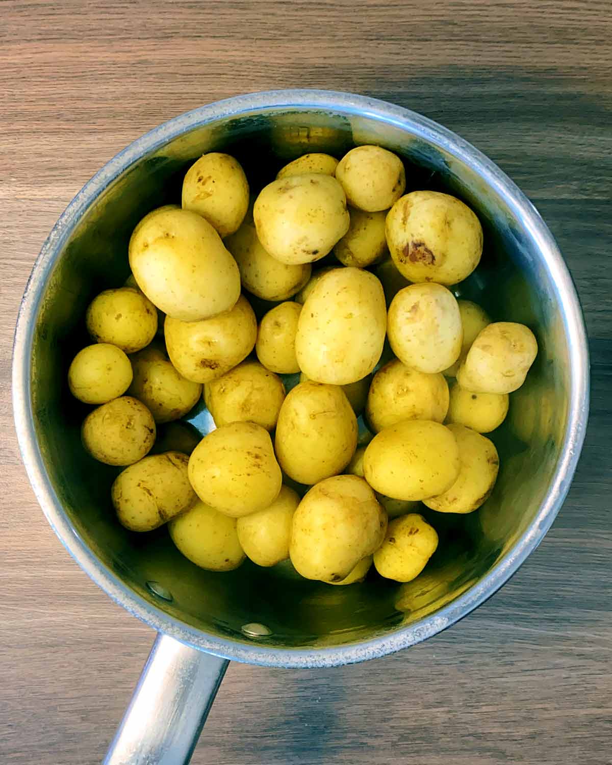 Wrinkled potatoes in a saucepan.