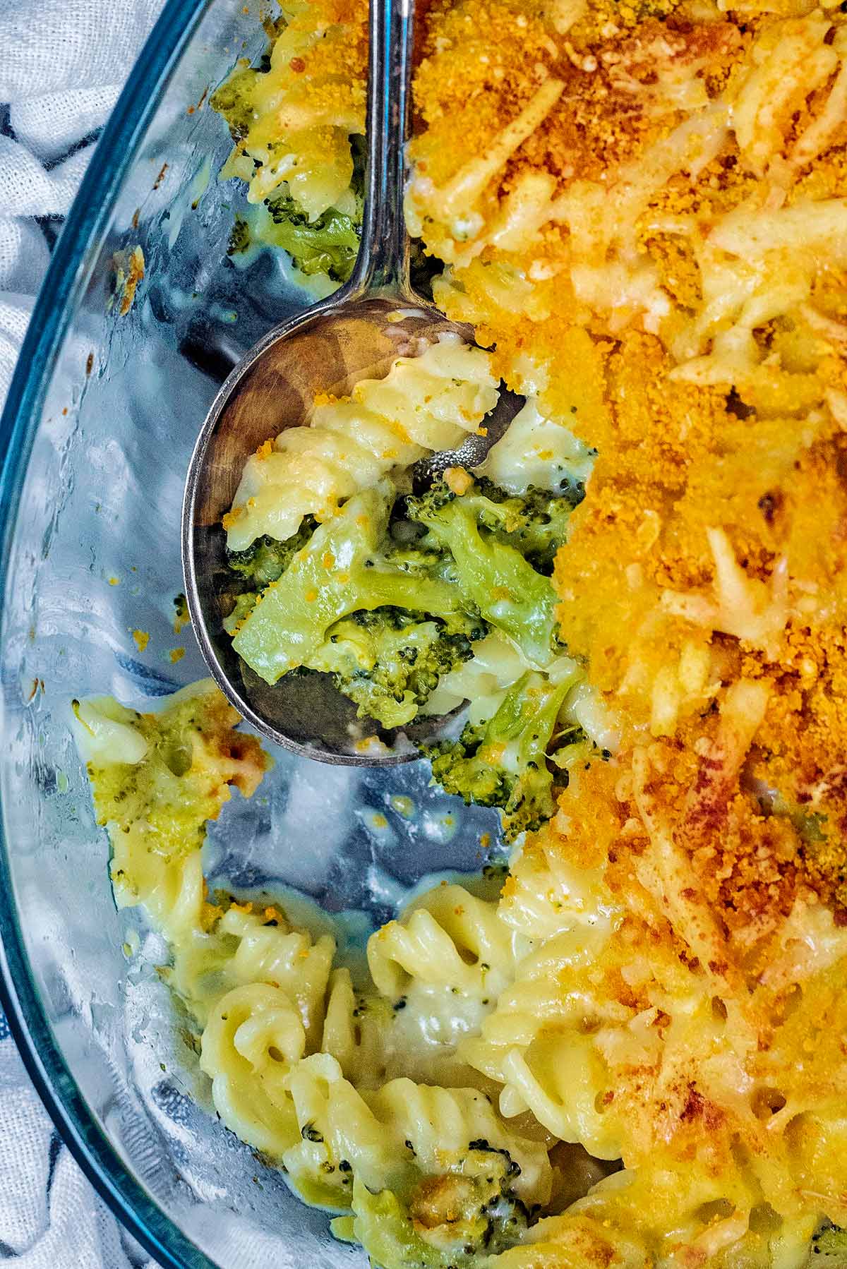 Pasta bake in a baking dish with a portion removed.