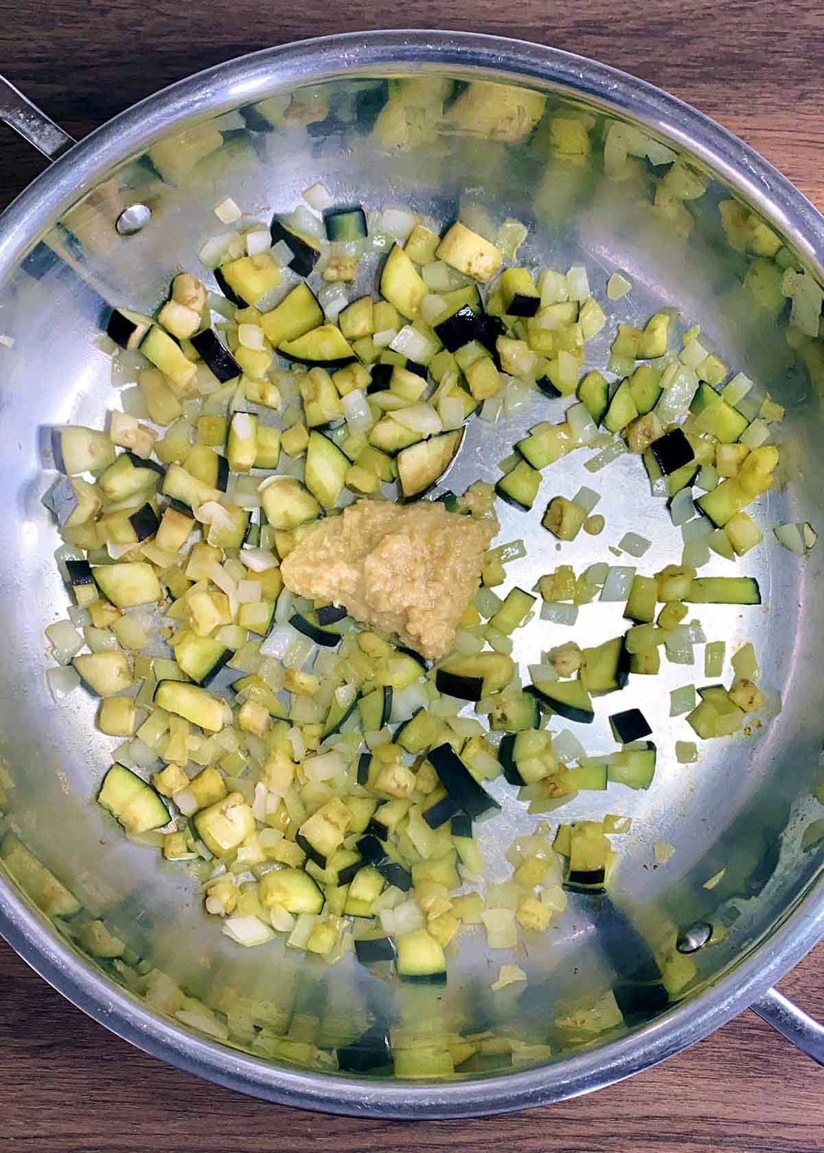 Garlic and ginger paste added to the pan.