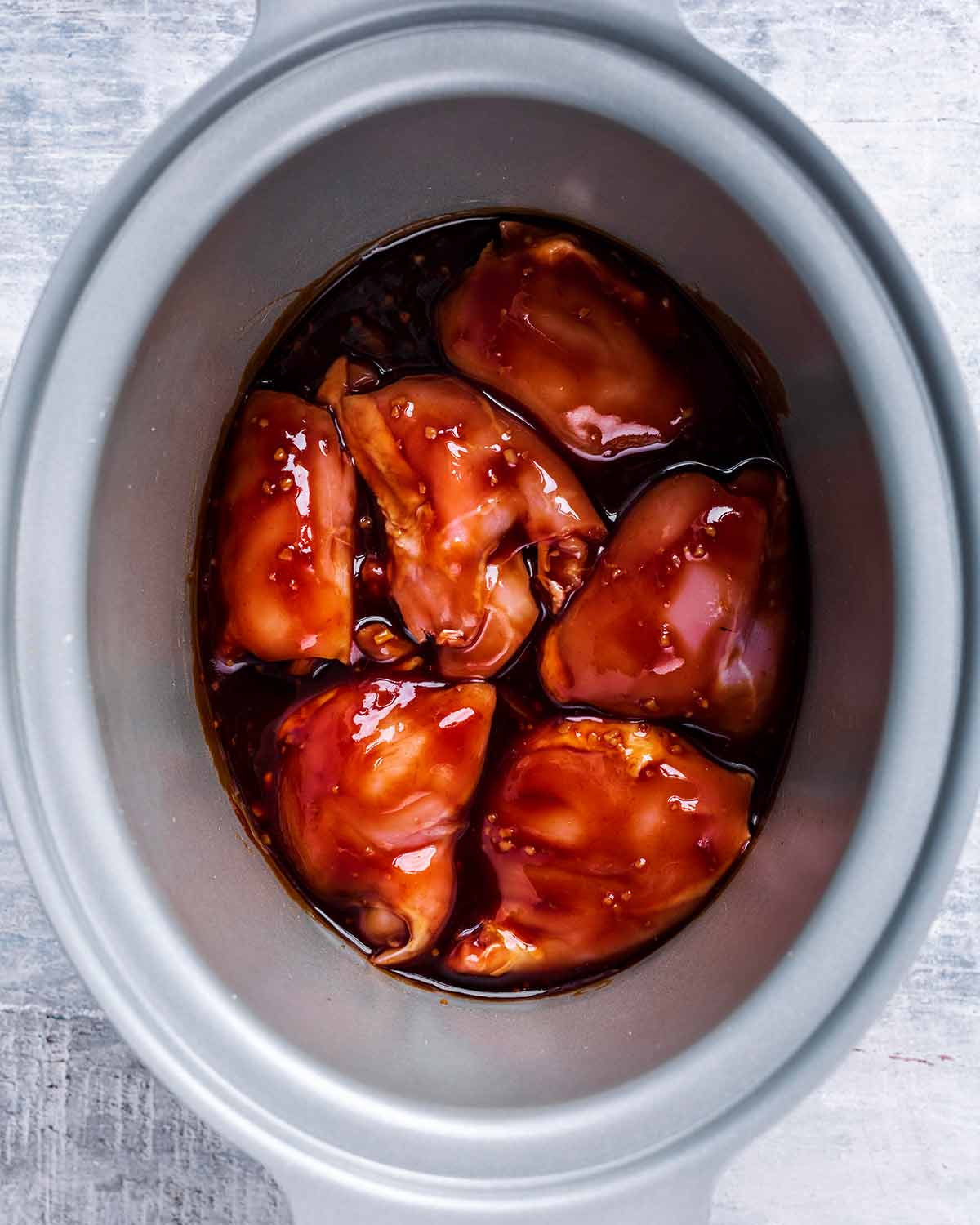 The chicken thighs covered in the soy tomato sauce.