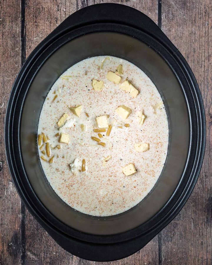 Milk added to the slow cooker bowl.