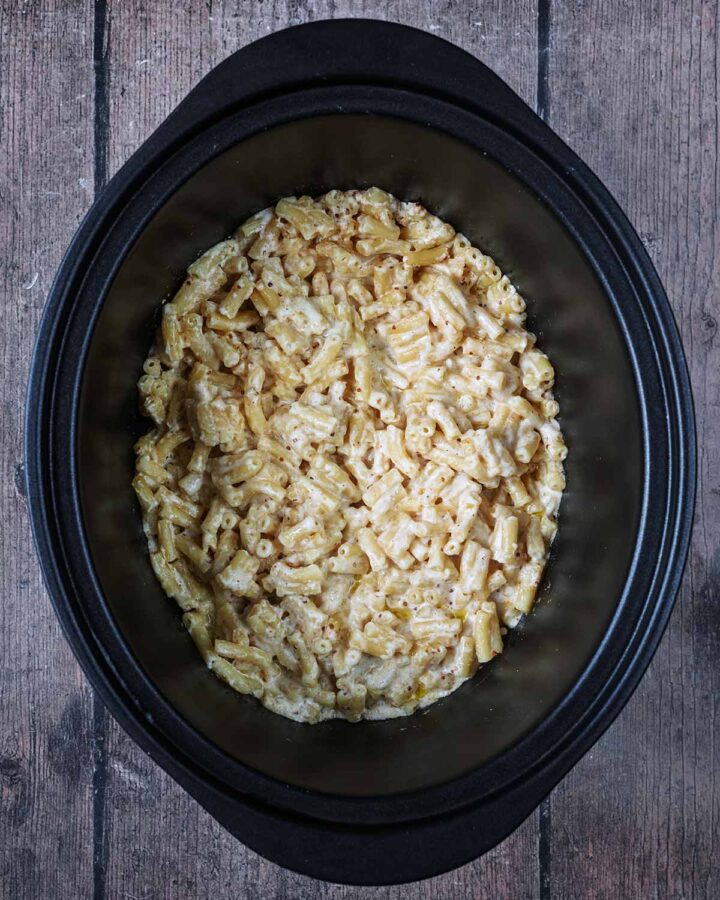 Cooked mac and cheese in the slow cooker bowl.