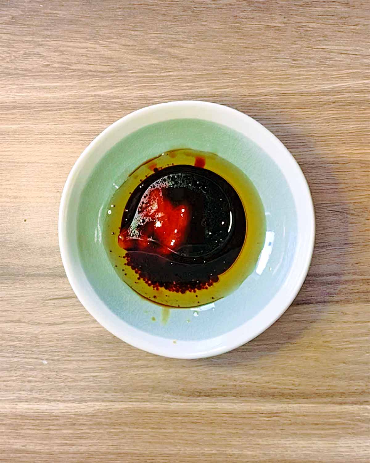 A small bowl of soy based sauce.