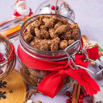 Cinnamon Roasted Almonds in a jar with a red ribbon.