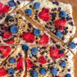 Frozen yogurt bark topped with berries and chocolate chips.