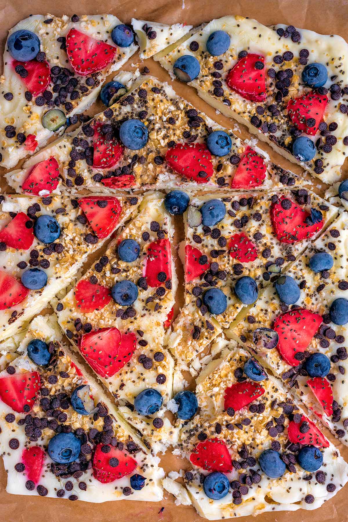 Blueberries and strawberries on top of broken yogurt bark.