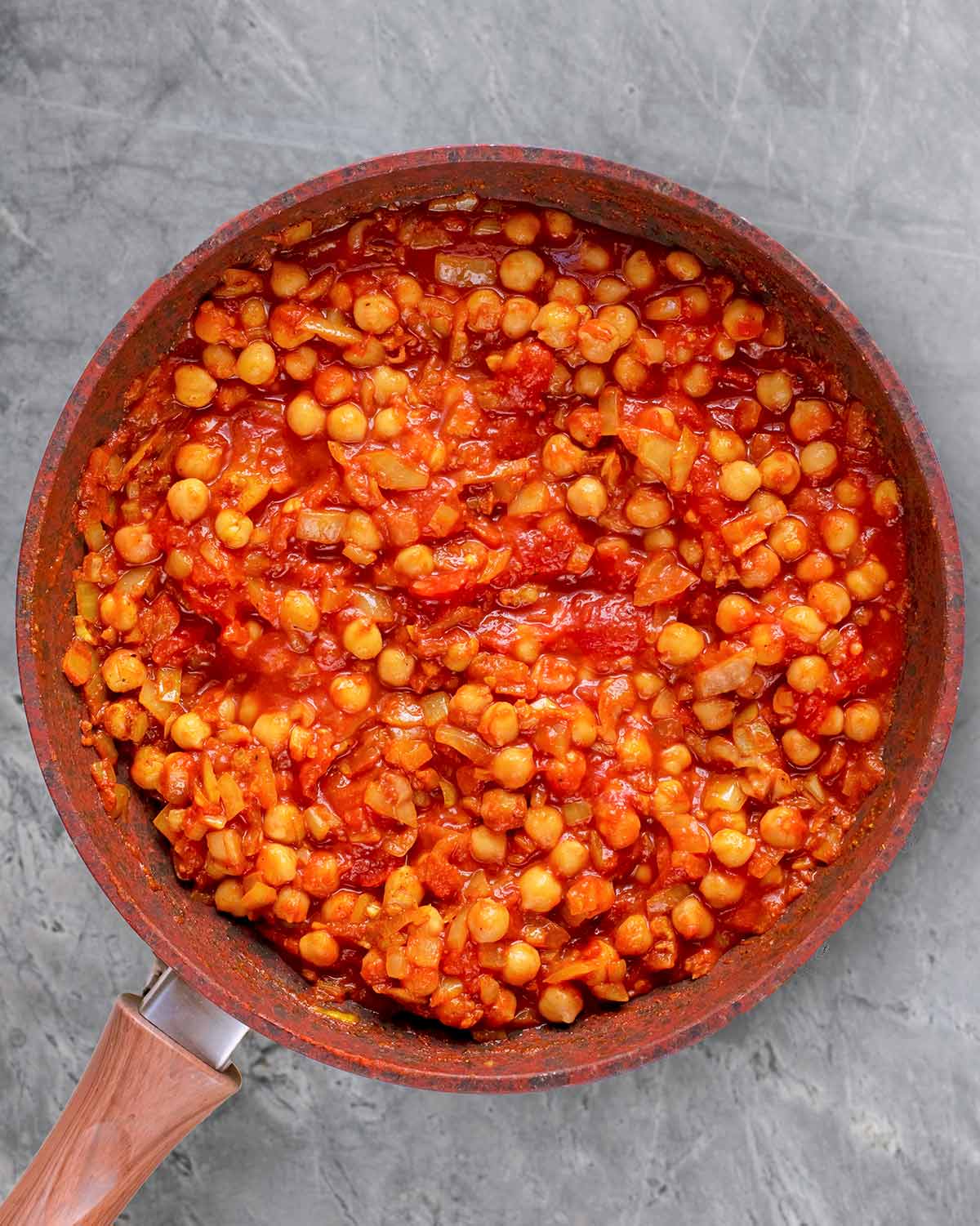 Chopped tomatoes and chickpeas added to the pan and mixed in.