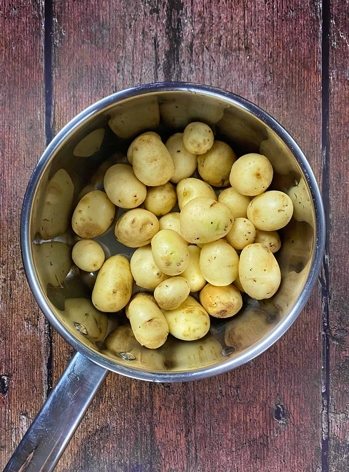 A saucepan containing new potatoes.