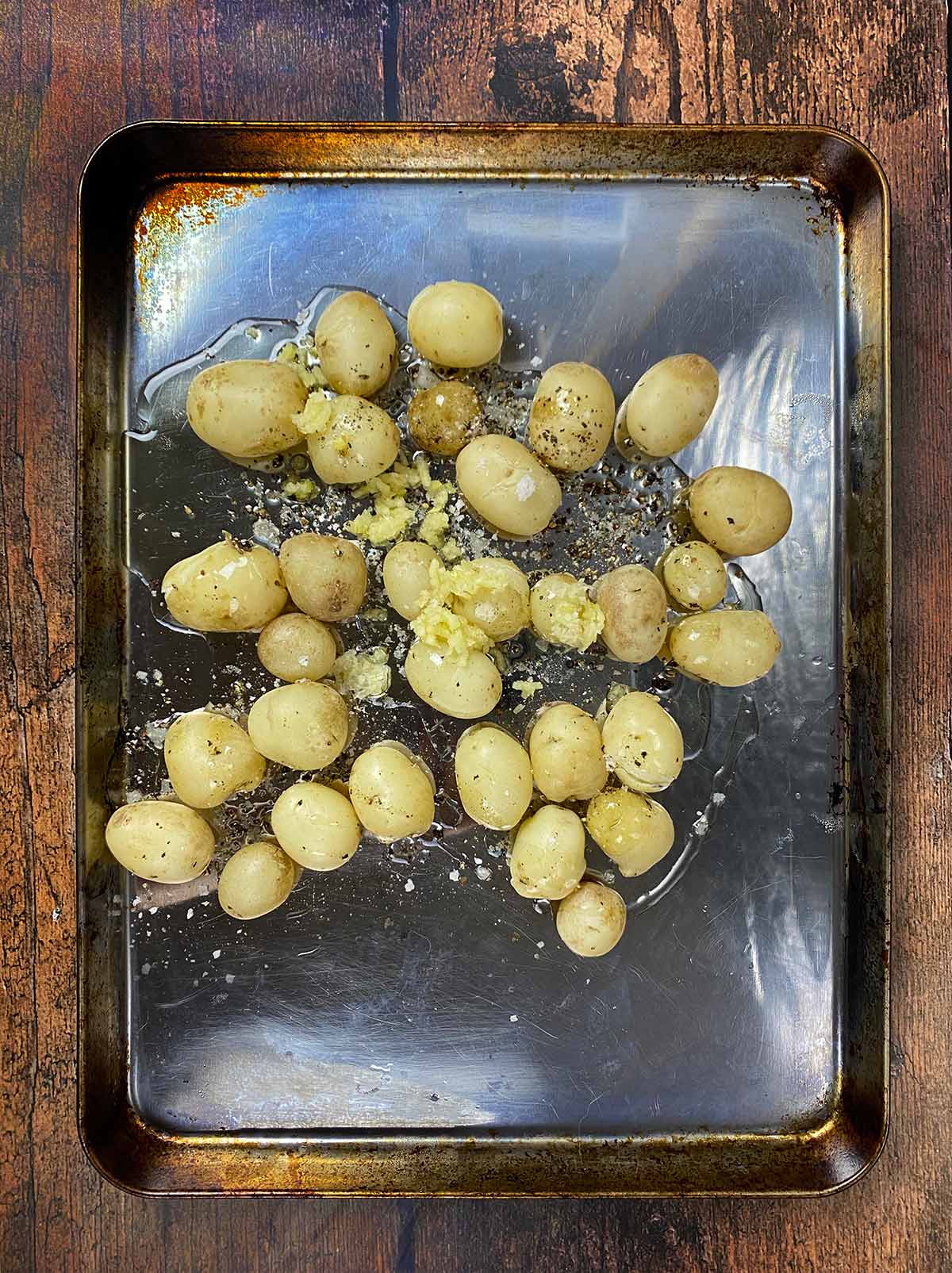 Oil and crushed garlic added to the potatoes.