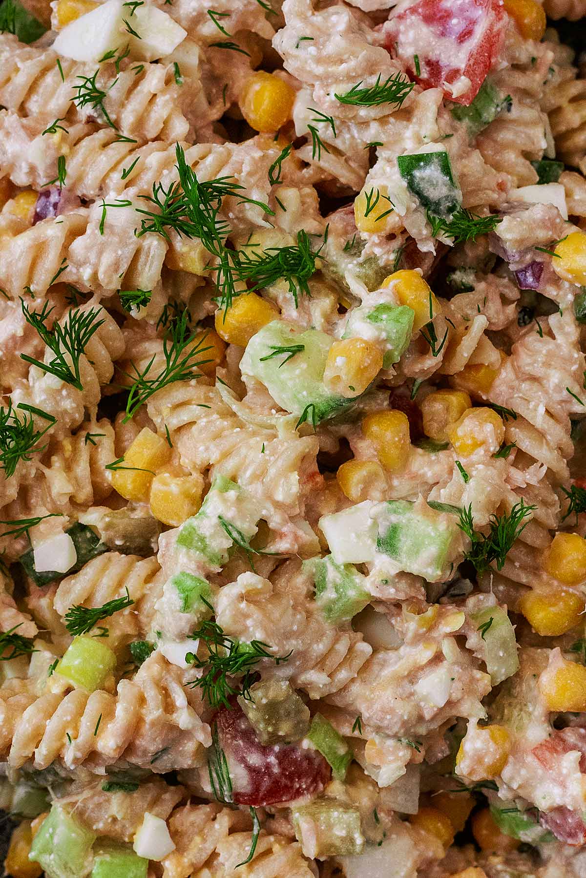 Cooked pasta, tuna chunks, chopped vegetables and dill in a creamy sauce.