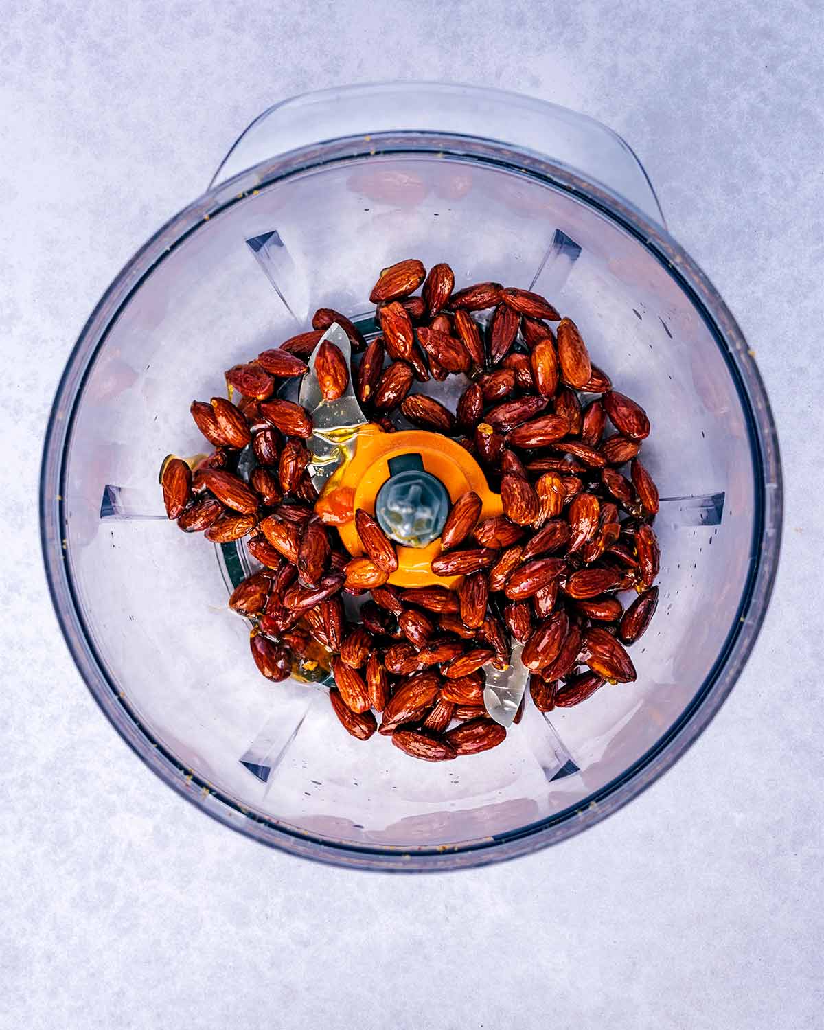 Roasted almonds in a food processor.