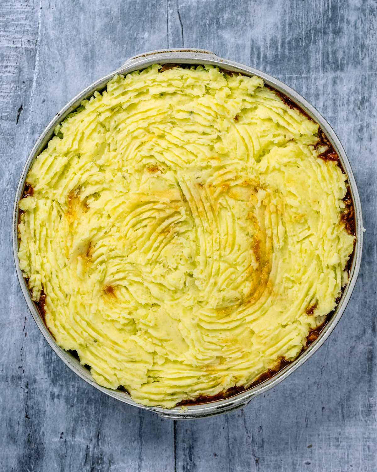 Mashed potato added on top of the cooke mince and veg.