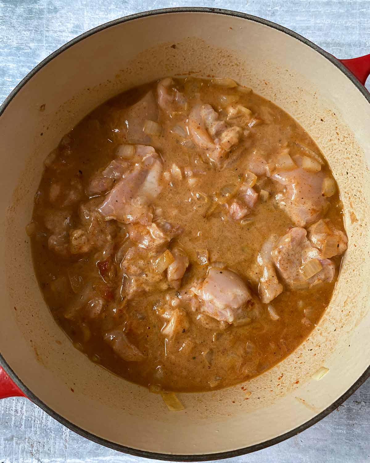 Chicken chunks in a brown curry sauce.