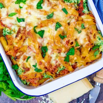 Spinach and ricotta pasta bake in a white baking dish.