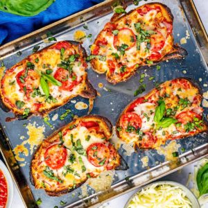 Four slices of pizza toast on a baking tray.