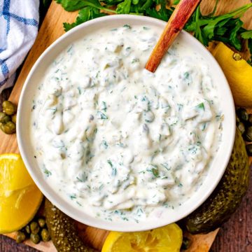 A bowl of easy tartare sauce with a spoon in it.