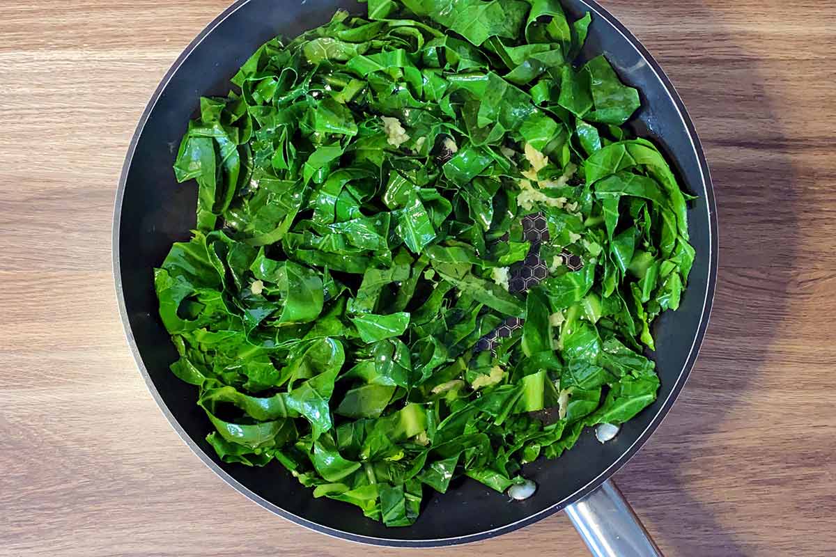 Cooked spring greens in the pan.