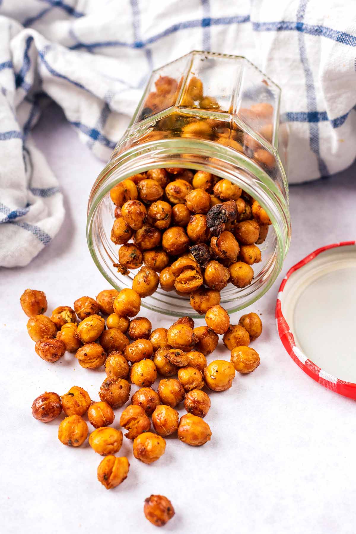 A jar on its side with chickpeas spilling out.