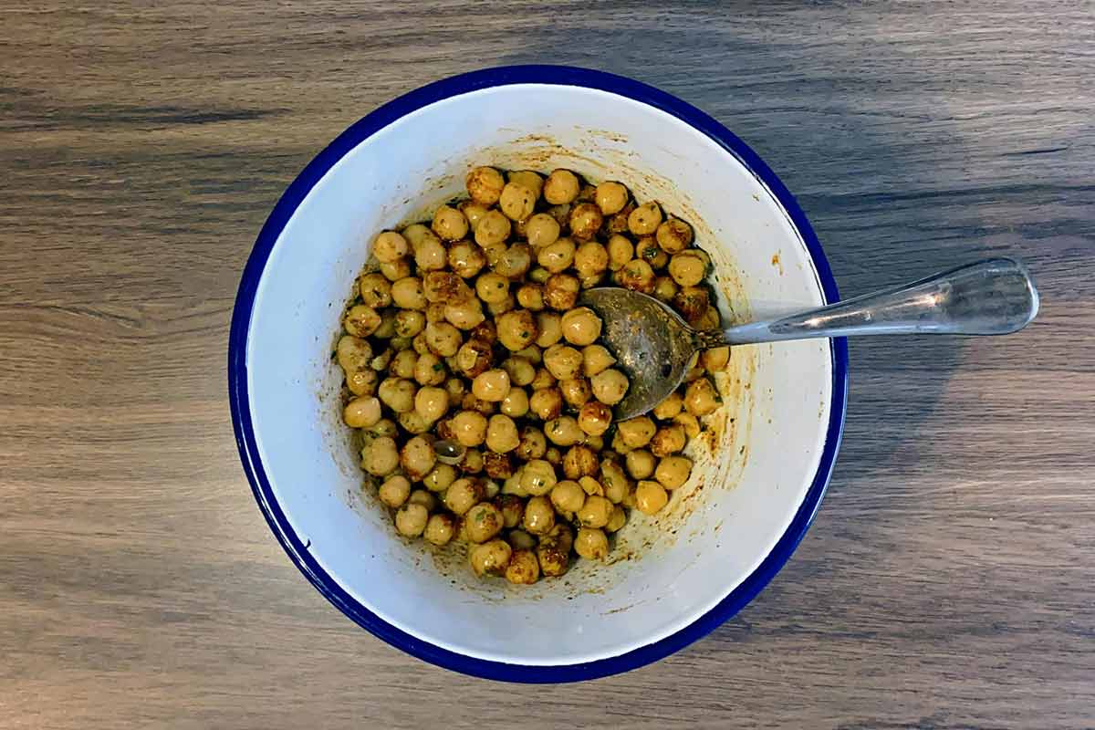 The chickpeas in the bowl mixed together with the spices.