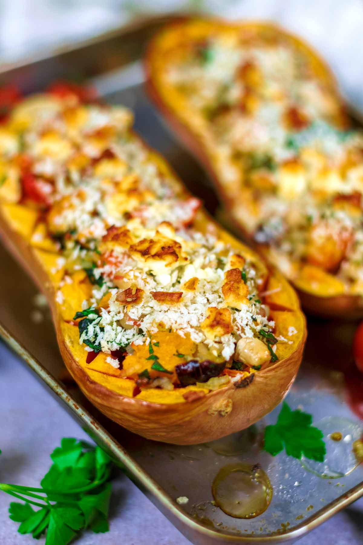 A stuffed butternut squash topped with breadcrumbs and charred feta cheese.