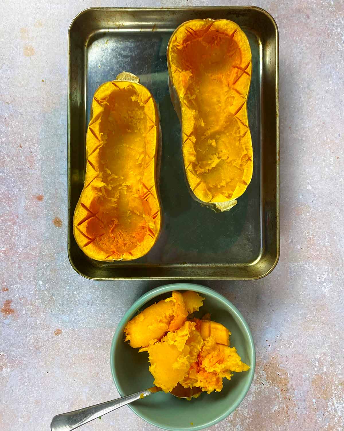 Roasted butternut squash halves with the flesh scooped out.