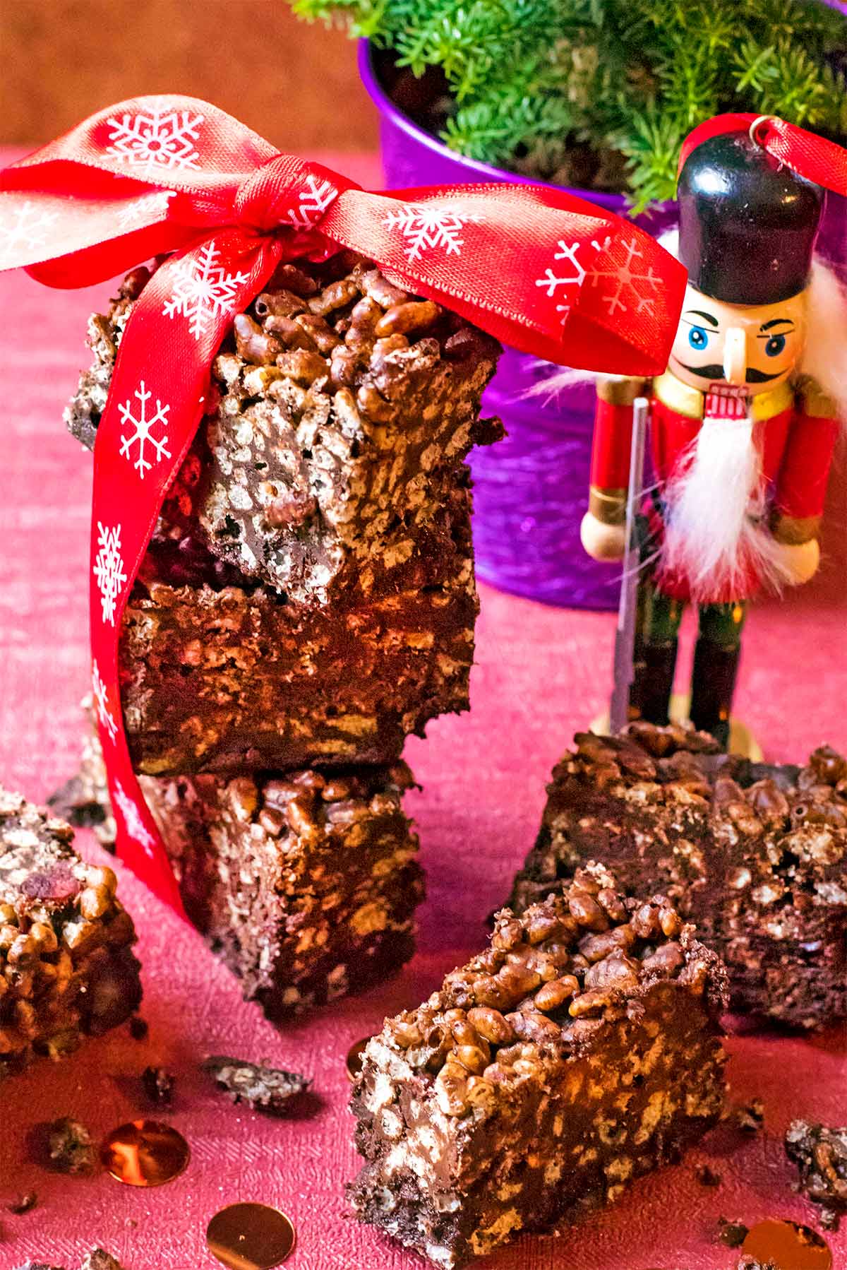 Rice Krispie bars tied with a red bow. A toy soldier stands next to them.