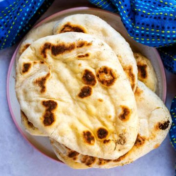 A stack of easy naan bread on a plate.