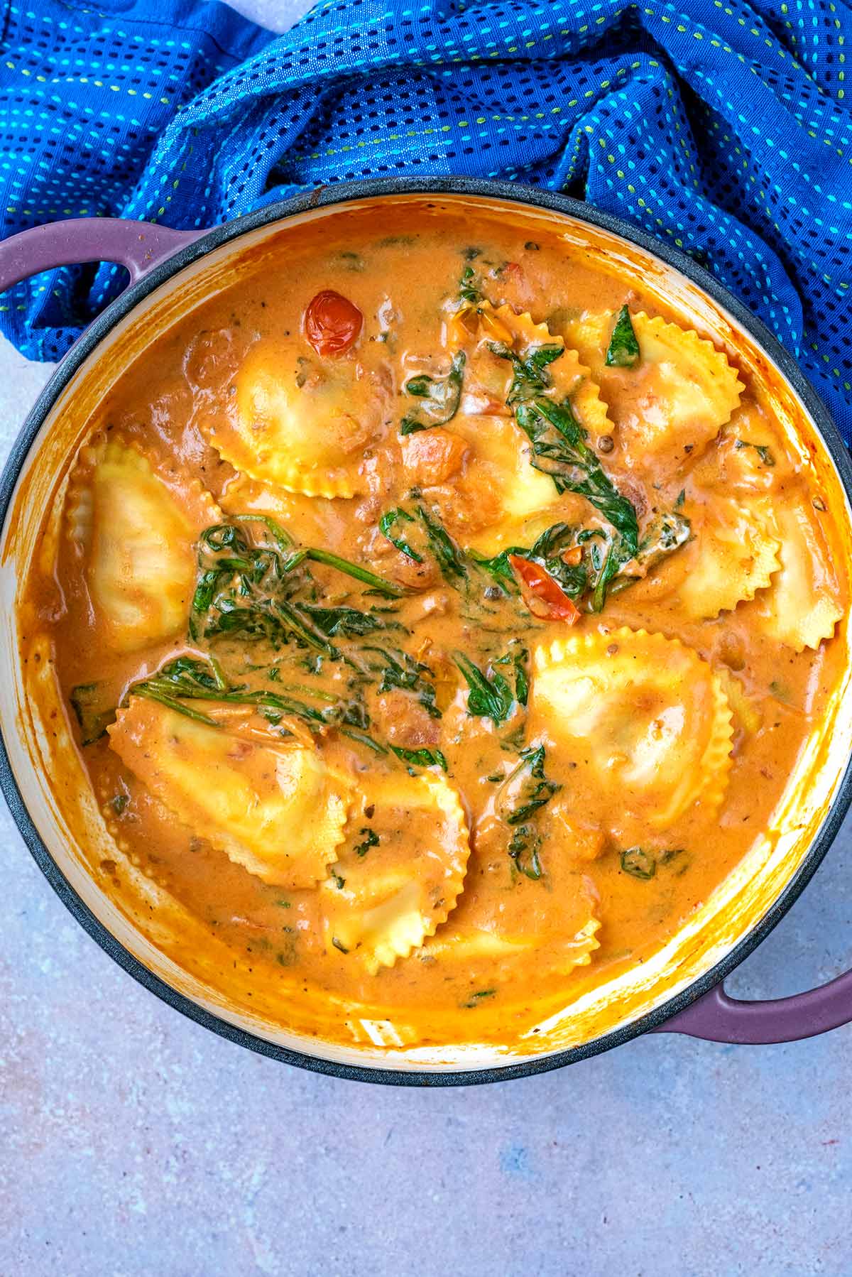 A large pan of ravioli in a sauce.