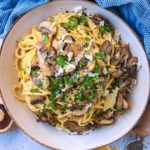 Mushroom Carbonara topped with chopped herbs and Parmesan shavings.