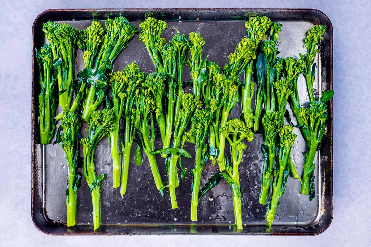 A baking tray covered in tenderstem broccoli.