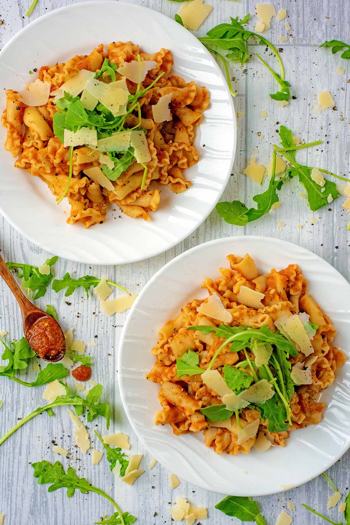 Two bowls of pasta in slow cooker pasta sauce.