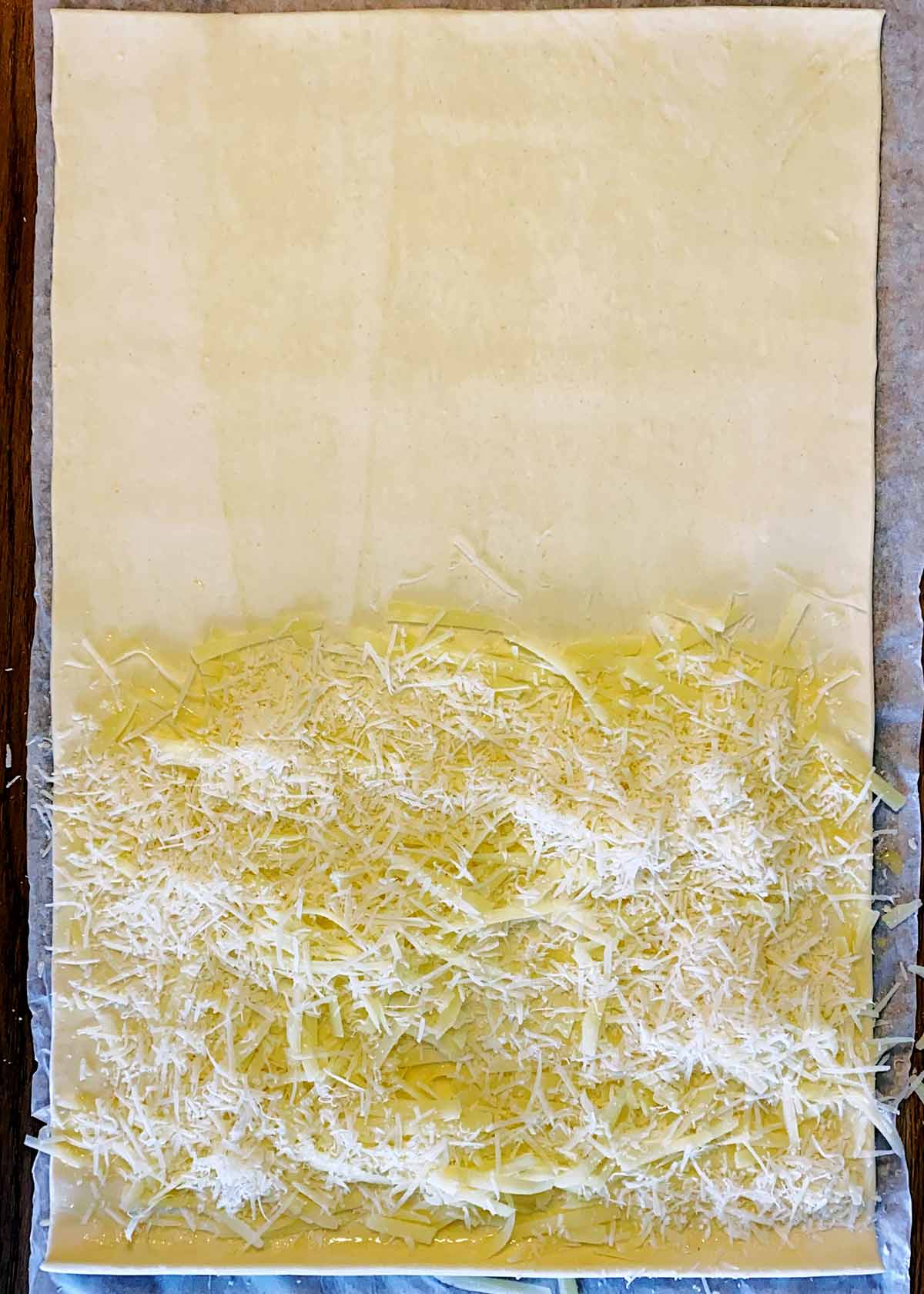 Grated cheese sprinkled over the egg washed half.