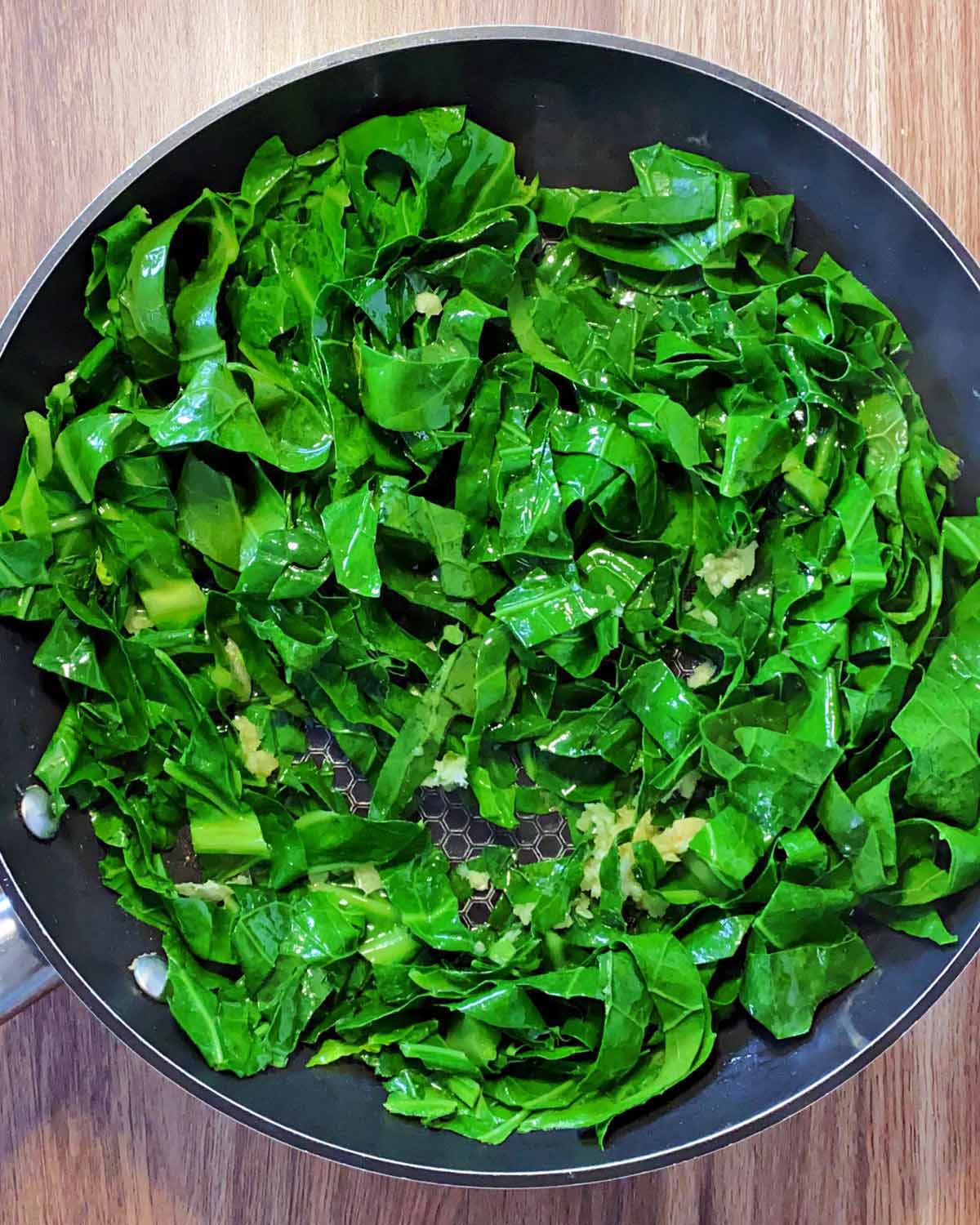 Cooked spring greens in the pan.