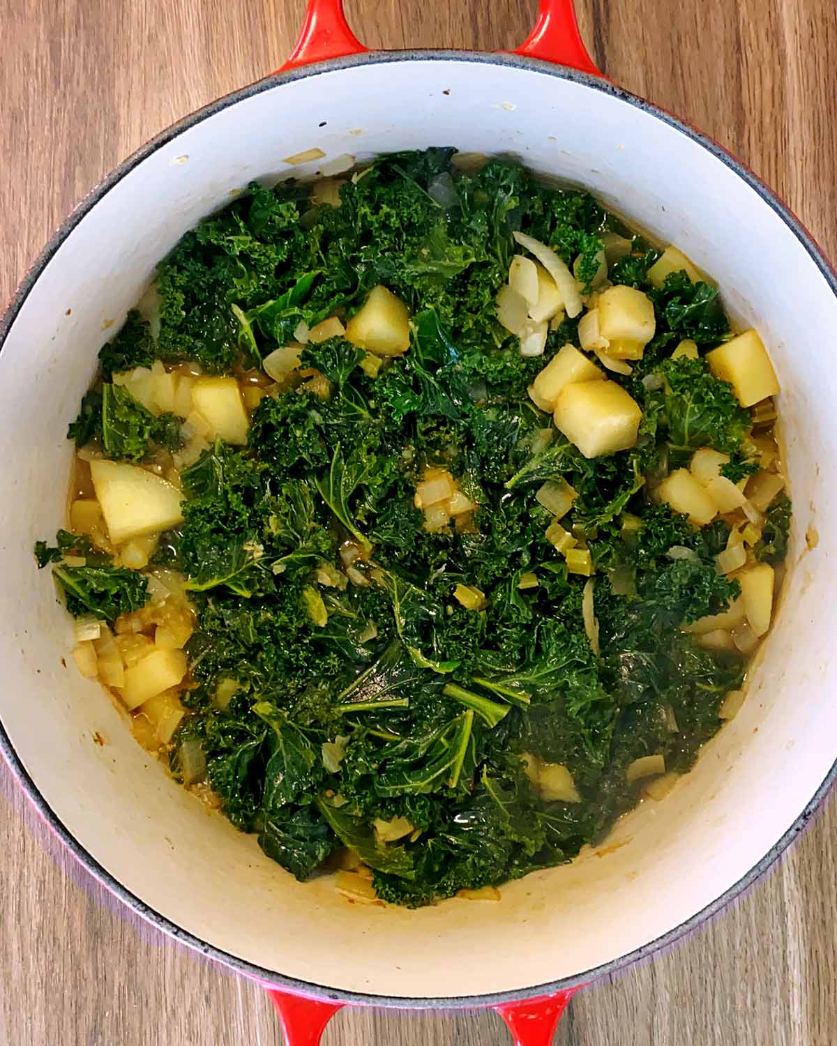 Kale and stock added to the pan.