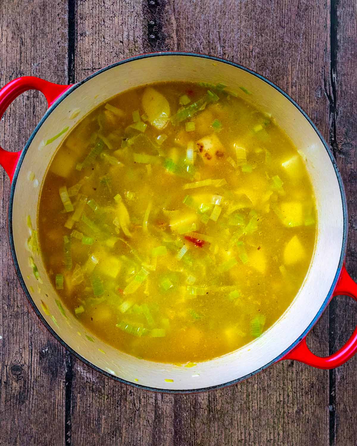 Stock added to the pan of vegetables.