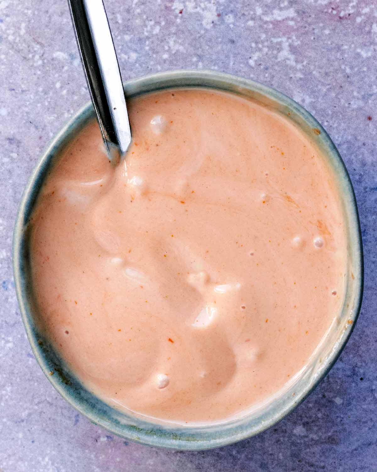 Marie Rose sauce in a bowl with a spoon.