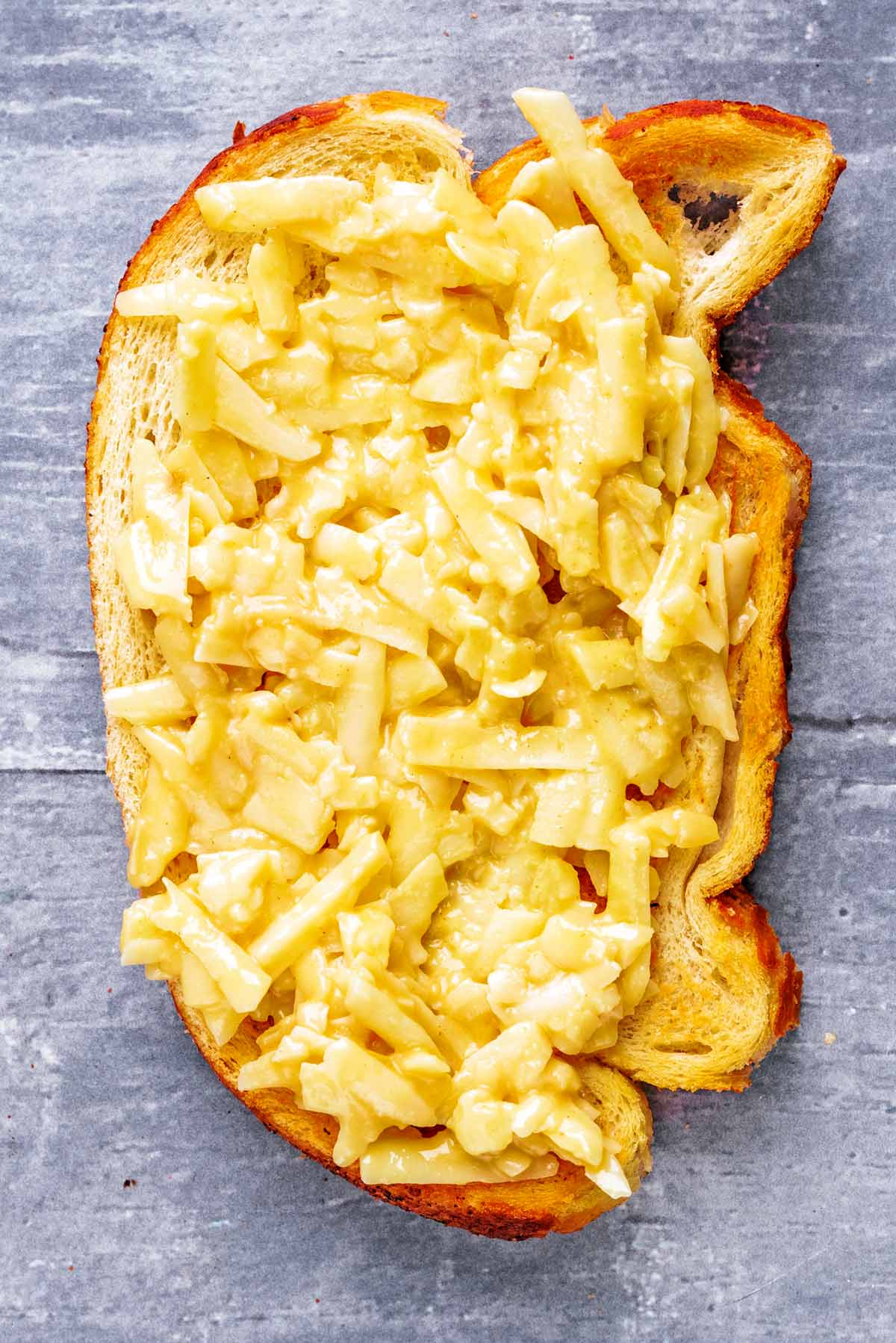 The cheese mixture spread over a slice of toasted bread.