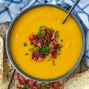 A bowl of butter bean soup topped with bacon and chives.