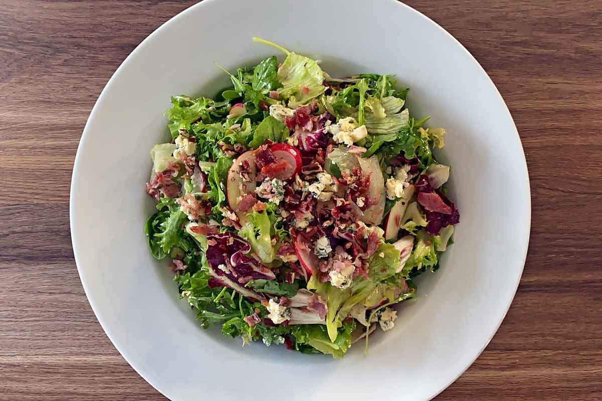 The salad transfered to a serving bowl and topped with crushed pecans.