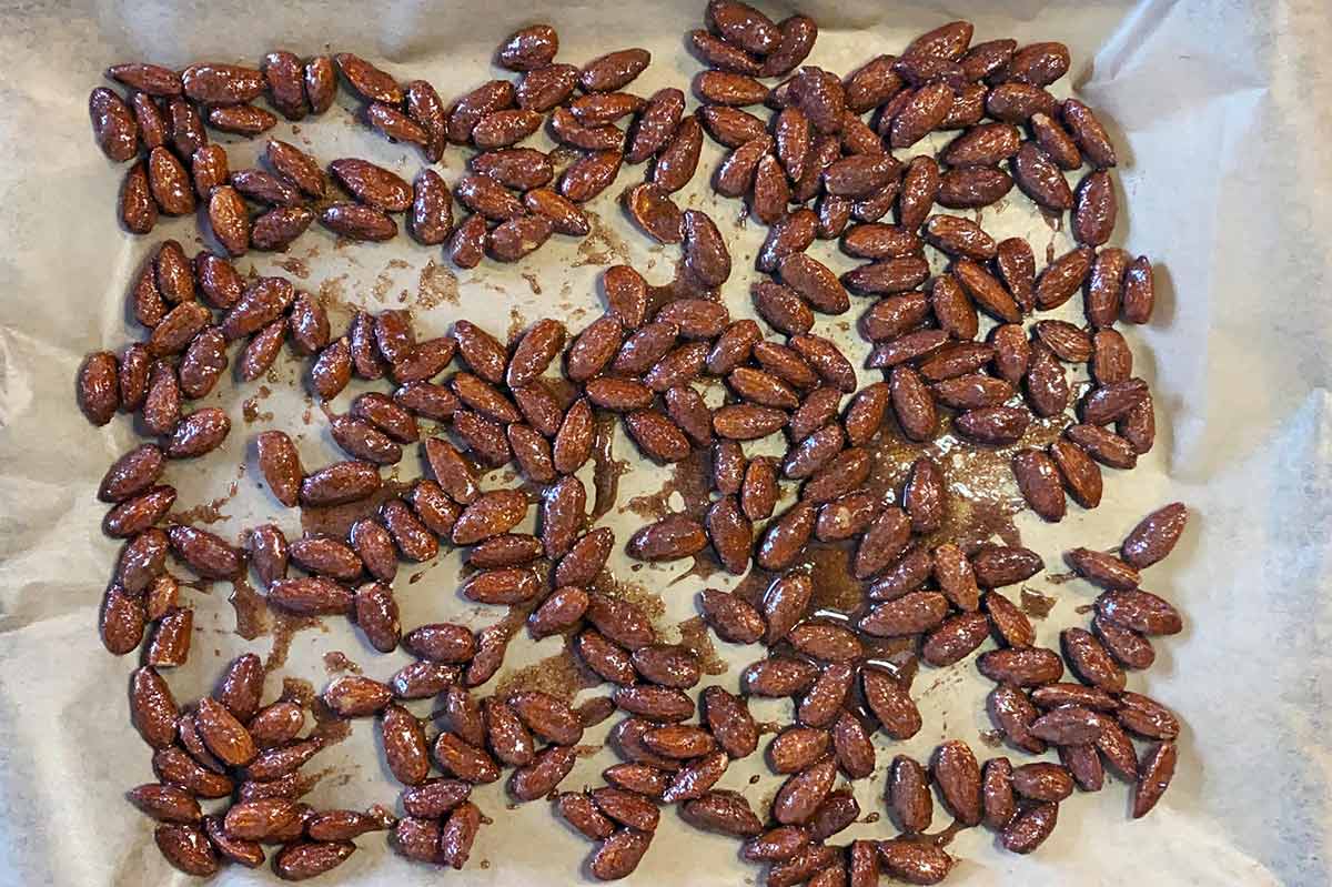 The almonds spread over a lined baking tray.