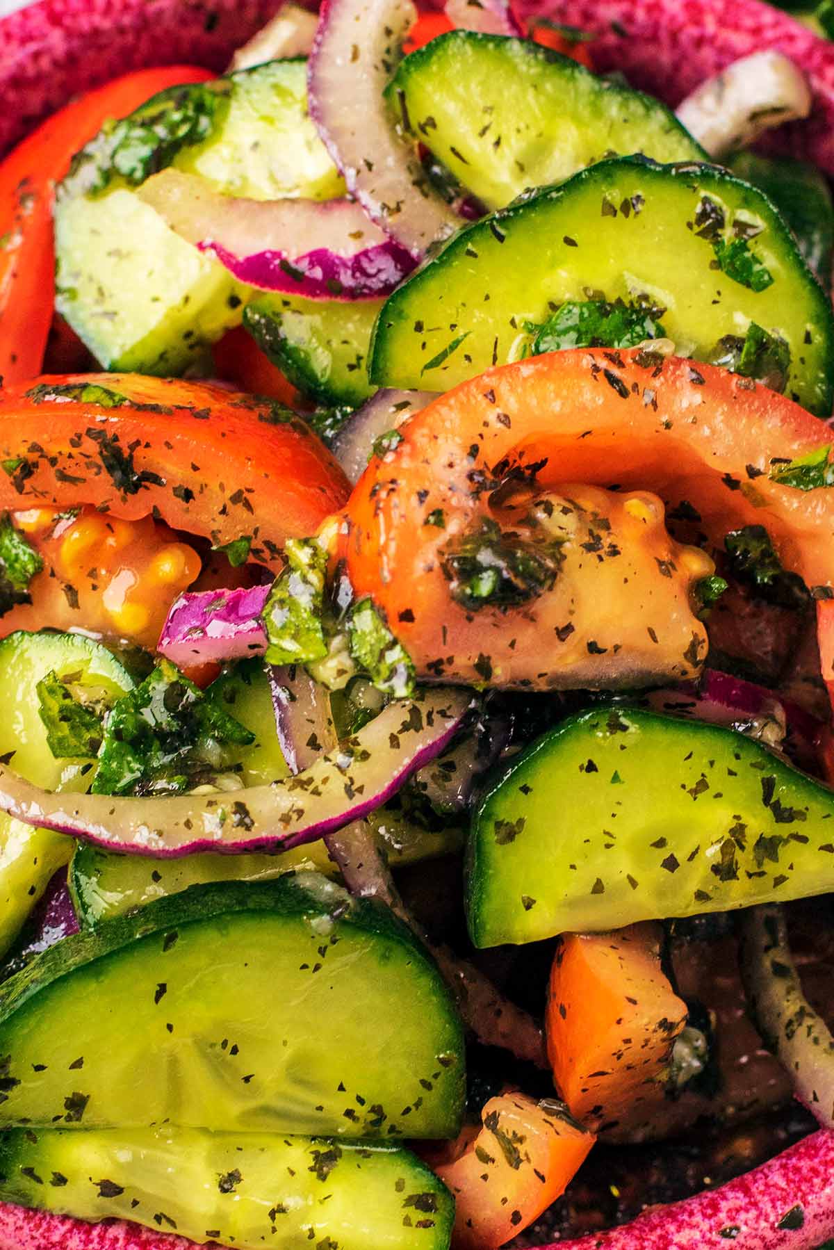 Sliced cucumbers, tomatoes and red onion coated in mint sauce.