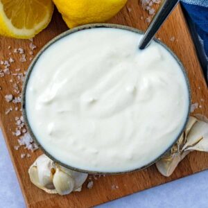 Easy Garlic Sauce in a bowl on a wooden board.