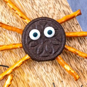 Oreo spiders on a wooden serving board.