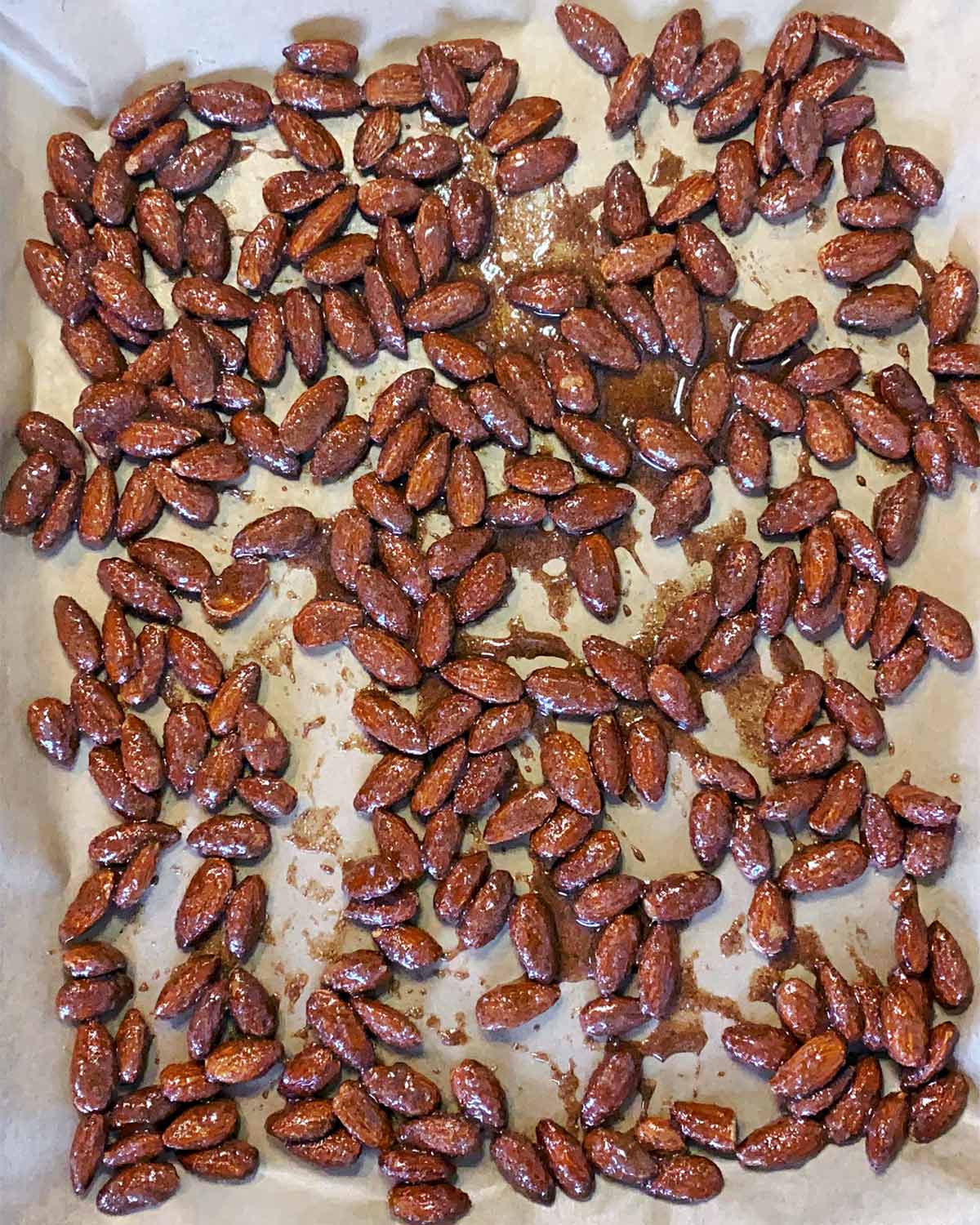 The almonds spread over a lined baking tray.