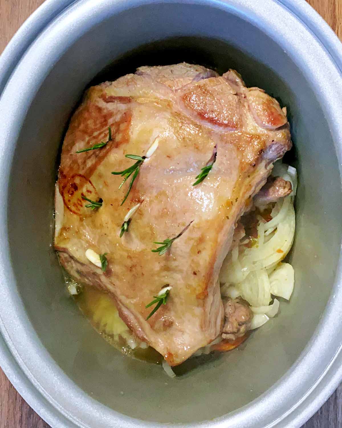 Rosemary leaves and garlic studded into the lamb.