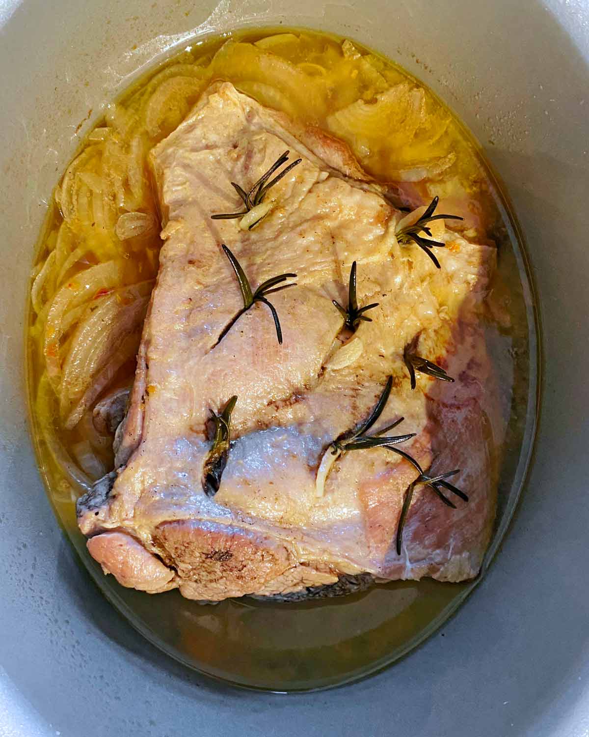 Cooked lamb shoulder in the slow cooker.