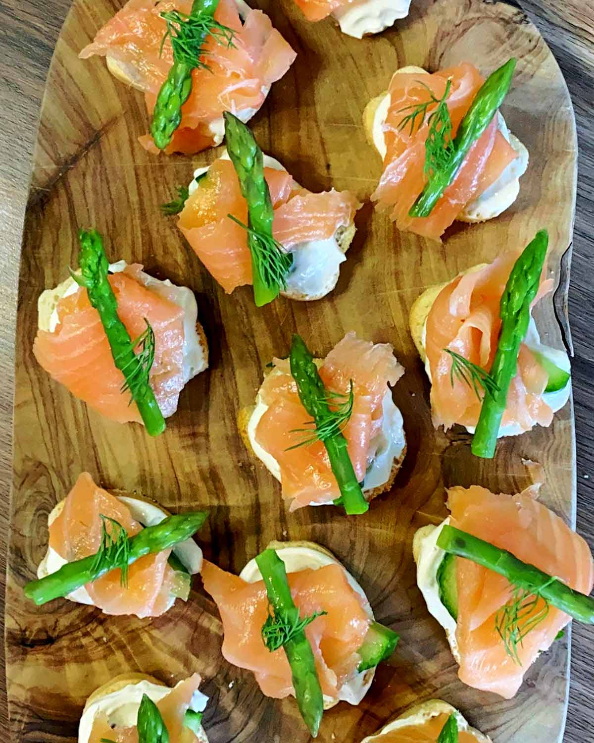 A cooked asparagus tip and some fresh dill added on top of the salmon.