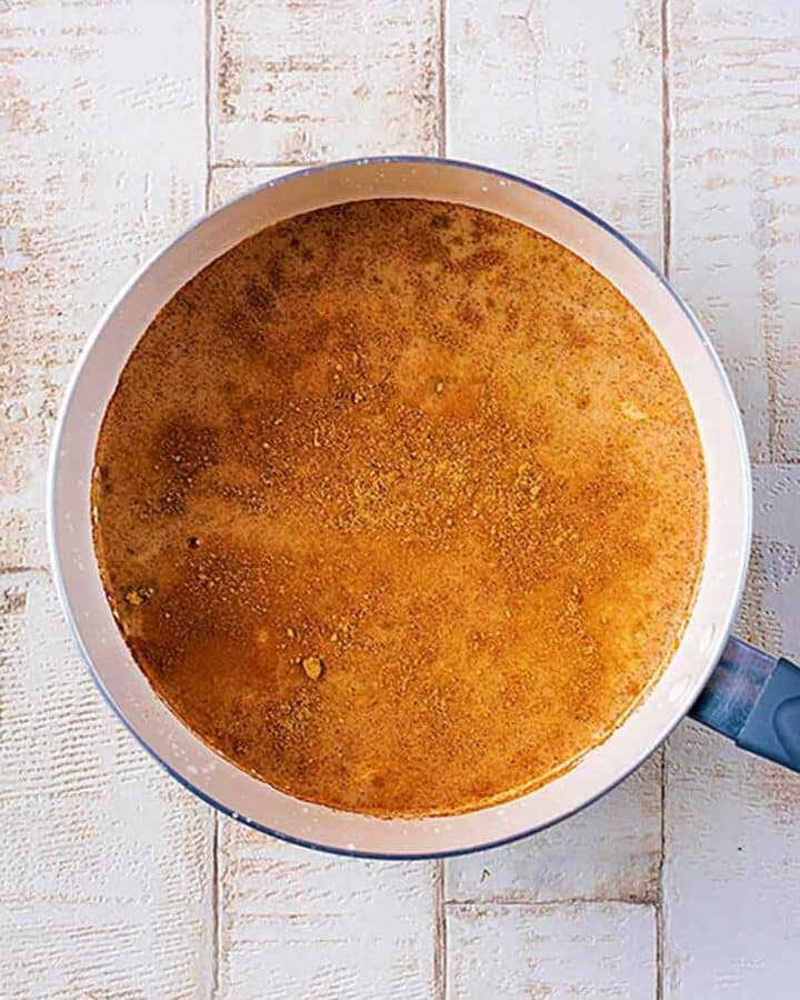 A saucepan containing all the ingredients to make eggnog.