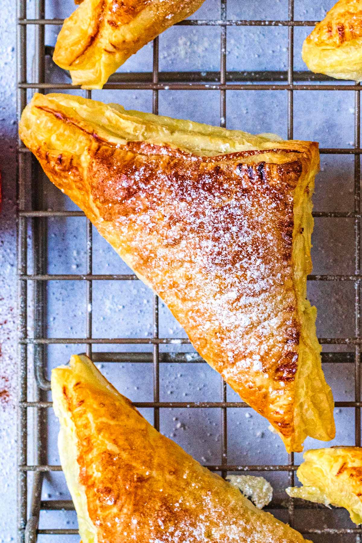 An apple turnover dusted with icing sugar.